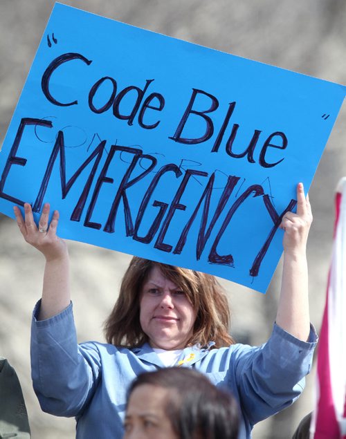 
RUTH / BONNEVILLE WINNIPEG FREE PRESS

Concordia Hospital health care worker Kim Pohl holds sign saying "Code Blue Emergency" along with other  concerned citizens and CUPE members as they hold rally in front of Concordia Hospital Tuesday to fight against the provincial governments plans to close the ER department and turn it into a Urgent Care facility.


April 11, 2017