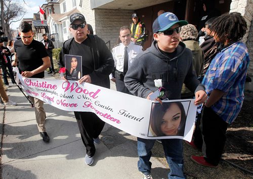 PHIL HOSSACK / WINNIPEG FREE PRESS  - Christine Wood's brothers Left to right, Ian,  Wendell and Bryan  carry a banner in memory during a vigil and march near the scene of her murder on Burrows ave to Thunderbird House Wednesday. ....See Carol's story.  -  April 12, 2017