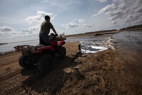 RUTH BONNEVILLE /  WINNIPEG FREE PRESS

Matt Van Steelandt a rancher in the Lauder area of southwestern Manitoba has to use his quad to get across to parts of his land after a municipal road was washed away  due to flooding in the area.  Steelandt stands on his quad on the end of the road with his quad looking across at his land on the other side.  
See Randy Turner  Flooding story.


April 12, 2017