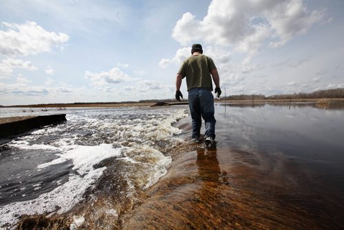 RUTH BONNEVILLE /  WINNIPEG FREE PRESS

Matt Van Steelandt a rancher in the Lauder area of southwestern Manitoba walks across a a dike spilling over with water to get across a municipal road  that connects his land that washed away due to flooding in area.  See Randy Turner  Flooding story.


April 12, 2017