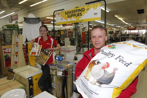 BORIS MINKEVICH / WINNIPEG FREE PRESS
From left, Peavey Mart Assistant Manager Renea Watson and store manager
Sam Spiropoulos pose with some honey-bee-related equipment/supplies and some chick feed. The company just announced it will be opening a second Winnipeg outlet this fall on south Pembina Highway. Murray McNeill story. April 13, 2017