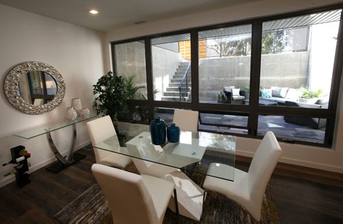WAYNE GLOWACKI / WINNIPEG FREE PRESS
Homes. The infill condo project at 218 Enfield Crescent in St. Boniface. A view of the dining area and courtyard through the window of the main floor condo. Todd Lewys story April 13 2017