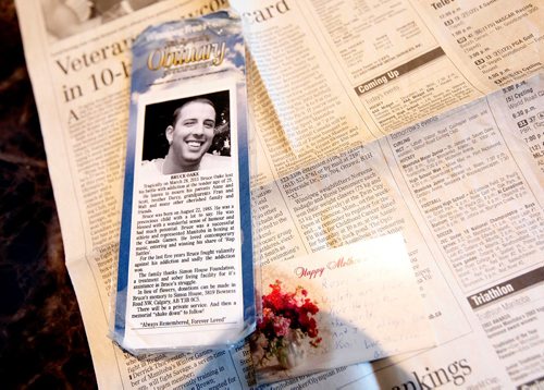 PHIL HOSSACK / WINNIPEG FREE PRESS  -  A bookmark with Bruce Oake's obituary is one of many pieces in his mother Anne's box of memoribilia. See Randy Turner's story. -  April 13, 2017