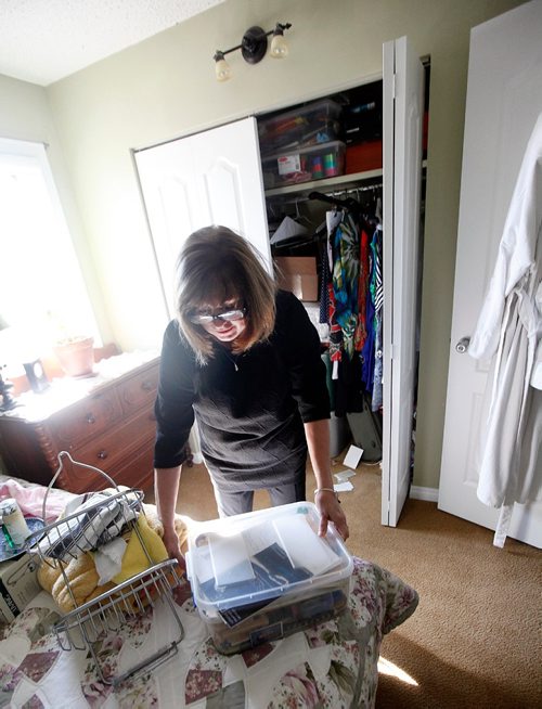 PHIL HOSSACK / WINNIPEG FREE PRESS  - Anne Oake pulls a tupperware container full of her son Bruce's memoribilia from a bedroom closet, She and her husband Scott and second son Darcy hope to turn this death into something positive for other addicts.  See Randy Turner's story. -  April 13, 2017