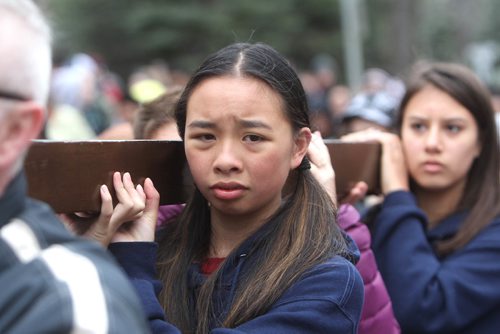 RUTH BONNEVILLE /  WINNIPEG FREE PRESS

Kaitlin Mestitu-Dao  a grade eight student at St. Mary's Academy, helps carry the cross through streets surrounding her school during the 30th Annual Public Way of the Cross on the morning of Good Friday.
Bishops, teachers and students took turns helping to carry the cross through the streets of Crescentwood led by singers and followed by a few thousand people.  The event was co-sponsored by St. Mary's Academy and the Archdiocese of Winnipeg Office of Youth and Young Adult Ministry. 
April 14, 2017
