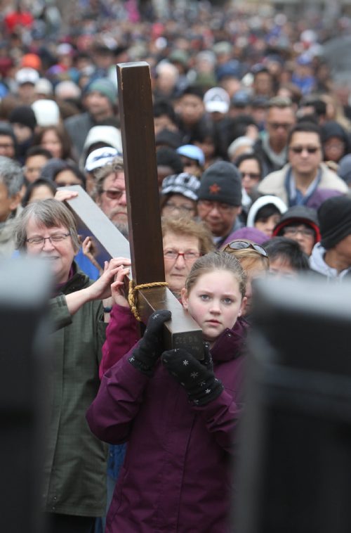 RUTH BONNEVILLE /  WINNIPEG FREE PRESS

Madeleine Lacoursiere a grade 7 student from Ecole Selkirk School,  helps carry the cross through streets surrounding her school during the 30th Annual Public Way of the Cross on the morning of Good Friday.
Bishops, teachers and students took turns helping to carry the cross through the streets of Crescentwood led by singers and followed by a few thousand people.  The event was co-sponsored by St. Mary's Academy and the Archdiocese of Winnipeg Office of Youth and Young Adult Ministry. 
April 14, 2017