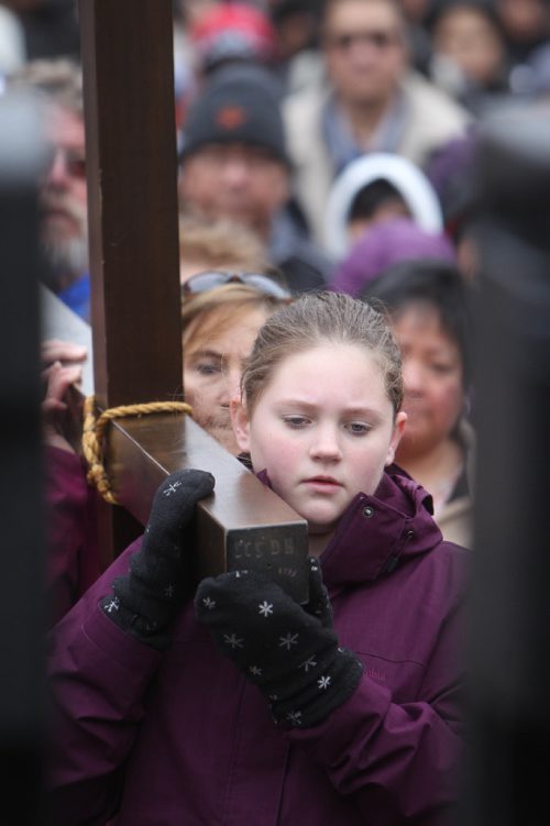 RUTH BONNEVILLE /  WINNIPEG FREE PRESS

Madeleine Lacoursiere a grade 7 student from Ecole Selkirk School,  helps carry the cross through streets surrounding her school during the 30th Annual Public Way of the Cross on the morning of Good Friday.
Bishops, teachers and students took turns helping to carry the cross through the streets of Crescentwood led by singers and followed by a few thousand people.  The event was co-sponsored by St. Mary's Academy and the Archdiocese of Winnipeg Office of Youth and Young Adult Ministry. 
April 14, 2017