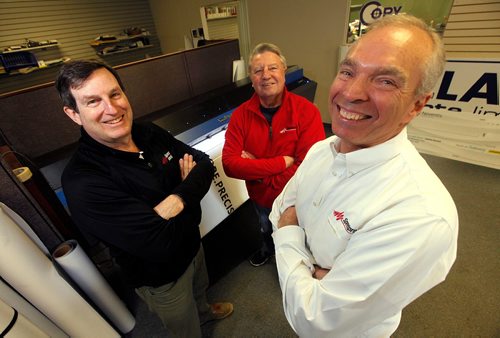 PHIL HOSSACK / WINNIPEG FREE PRESS  -  Left to right, Speedpro signs professionals Franchise owners Quentin MacCharles and Rick Henry (Centre) pose with CEO Stuart Burns (Right) Monday. See Martin Cash story......  -  April 17,  2017