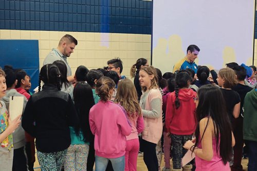 Canstar Community News Winnipeg Blue Bombers players Matthias Goosen (left) and Ian Wild (right) sign authographs after an anti-bullying presentation at Ecole Constable Edward Finney on April 11, 2017