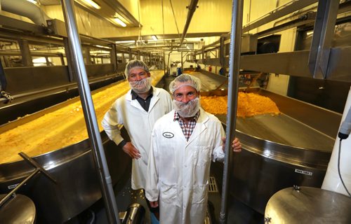 RUTH BONNEVILLE /  WINNIPEG FREE PRESS

Biz: Bothwell Cheese, Main St. N, New Bothwell, Mb. 
Bothwell Cheese company president KEVIN THOMSON (right)  and MIKE RAFTIS, vice-president of sales, in their cheese plant. Story is about how they have a new line of non-GMO-verified white cheddar cheese they have produced that will be hitting the store shelves later this summer.
April 18, 2017