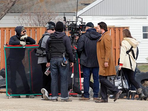 PHIL HOSSACK / WINNIPEG FREE PRESS  -  Keanu Reeves (tan coat right) walks through the outdoor set for Siberia in Marquette Manitoba Tuesday. See Alex Paul story.  -  April 18,  2017