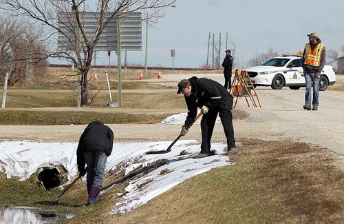 PHIL HOSSACK / WINNIPEG FREE PRESS  -  Siberia crew shovel gravel onto cotton "snow" in Marquette ditches Tuesday to keep the props from blowing away. See Alex Paul story.  -  April 18,  2017