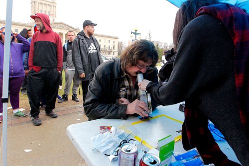 BORIS MINKEVICH / WINNIPEG FREE PRESS
420 celebrations at the Legislative Building grounds. A person takes a rip of some free THC extract from a kiosk set up at the Leg. April 20, 2017