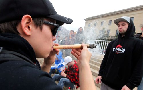 BORIS MINKEVICH / WINNIPEG FREE PRESS
420 celebrations at the Legislative Building grounds. An youth smokes a big joint on the steps of the Manitoba Legislature. April 20, 2017