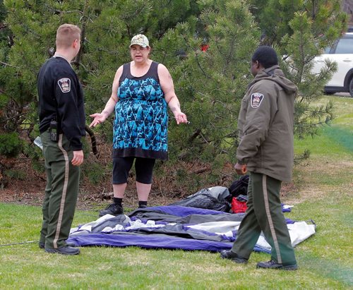 BORIS MINKEVICH / WINNIPEG FREE PRESS
420 celebrations at the Legislative Building grounds. A woman is told to not set up a tent on the grass. April 20, 2017