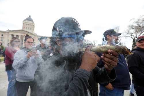 RUTH BONNEVILLE /  WINNIPEG FREE PRESS

People gather at the Manitoba Legislative grounds to celebrate 4/20 and smoke pot (cannabis, marihuana) Thursday. 
Anthony Cohen smokes huge dube at Leg with friends.    

 
April 20, 2017