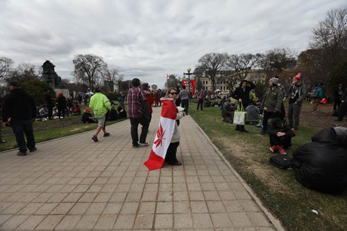 RUTH BONNEVILLE /  WINNIPEG FREE PRESS

People gather at the Manitoba Legislative grounds to celebrate 4/20 and smoke pot (cannabis, marihuana) Thursday.  
Woman wears flag with marihuana leaf on it.  
 
April 20, 2017