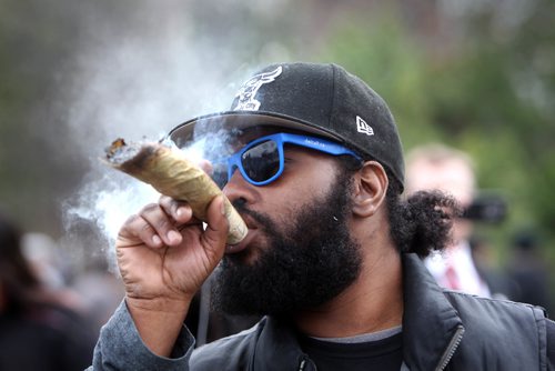 RUTH BONNEVILLE /  WINNIPEG FREE PRESS

People gather at the Manitoba Legislative grounds to celebrate 4/20 and smoke pot (cannabis, marihuana) Thursday. 
Anthony Cohen smokes huge dube at Leg with friends.    

 
April 20, 2017