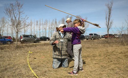 MIKE DEAL / WINNIPEG FREE PRESS
Volunteer Peter H. helps Grace Kammerlock-Butcher, 6, try out an Atl Atl during the FortWhyte Alive annual Earth Day celebration on Sunday.
170423 - Sunday, April 23, 2017.