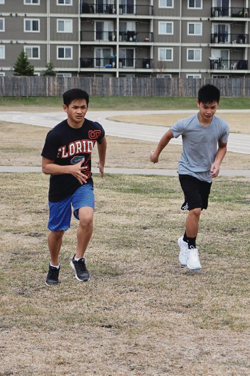 Canstar Community News April 20, 2017 - Jestoni Villanueva (left) and James Jose (right) warm up for a track and field practice during lunch (LIGIA BRAIDOTTI/CANSTAR COMMUNITY NEWS/TIMES)