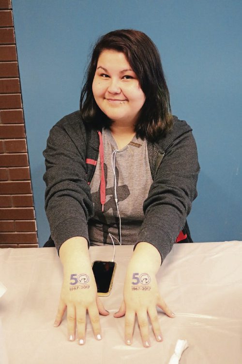Canstar Community News April 20, 2017 - R.B. Russell Grade 10 student Ryann Moar distributes fake tatoos in celebration of the schools 50th anniversary. (LIGIA BRAIDOTTI/CANSTAR COMMUNITY NEWS/TIMES)