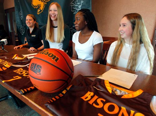 BORIS MINKEVICH / WINNIPEG FREE PRESS
University of Manitoba Bison athletics press conference at Smitty's 2835 Pembina Hwy.  From left, Bison women's basketball head coach Michele Sung (Hynes), Dana Inglis, Bettina Shyllon, and Deidre Bartlett. Here they wait to sign papers to join the Bisons Women's basketball team. April 24, 2017