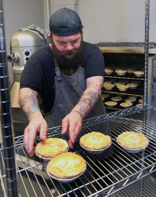 WAYNE GLOWACKI / WINNIPEG FREE PRESS

49.8 INTERSECTION.  Dustin takes hot pot pies out of the oven.   Dustin Watson is the Lord of the Pies, he founded the biz in Sept 2016 . He is working in the United community kitchen to prepare his pies. Dave Sanderson story. April 24 2017