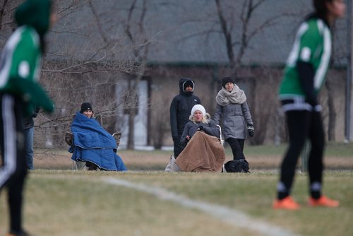 JOHN WOODS / WINNIPEG FREE PRESS
Supporters of Linden Christian Wings (green) and Faith Academy Lightning (blue) try to keep warm as they play in the snow at Simkin Park Monday, April 24, 2017.
