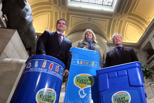 WAYNE GLOWACKI / WINNIPEG FREE PRESS

  Cathy Cox, Sustainable Development Minister holds up a new recycling bin bag for cottages and seasonal sites with at left Tom Thiessen, executive director, Building Owners and Managers Association of Manitoba  and Ken Friesen, executive director, Canadian Beverage Container Recycling Association in the Manitoba Legislative bld. Tuesday to announce new partnered recycling initiatives. The two other bins are used for commercial spaces. Nick Martin  story. April 25 2017