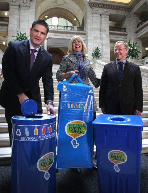 WAYNE GLOWACKI / WINNIPEG FREE PRESS

  Cathy Cox, Sustainable Development Minister holds up a new recycling bin bag for cottages and seasonal sites with at left Tom Thiessen, executive director, Building Owners and Managers Association of Manitoba and Ken Friesen, executive director, Canadian Beverage Container Recycling Association in the Manitoba Legislative bld. Tuesday to announce new partnered recycling initiatives. The two other bins are used for commercial spaces. Nick Martin  story. April 25 2017