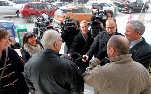 BORIS MINKEVICH / WINNIPEG FREE PRESS
Senior citizen James Aisaican-Chase has terminal cancer and is fighting a red light ticket. He appeared in court this morning. Wise up Winnipeg is using the case to advocate for longer amber lights. Press scrum outside of traffic court at 373 broadway avenue. From left backs facing media, James Aisaican-Chase (white hair), Todd Dube (tan jacket) from Wise up Winnipeg, and engineer David Grant talk to the press outside traffic court at 373 Broadway Avenue. JANE GERSTER STORY April 26, 2017