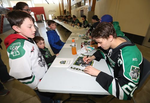 TREVOR HAGAN / WINNIPEG FREE PRESS
From left, Anthony, 10, Jake 4, and Lucas Ammeter, 7, getting an autograph from Riley Thiessen, captain of the Portage Terriers, at a rally at Stride Place in Portage la Prairie, Wednesday, April 26, 2017.