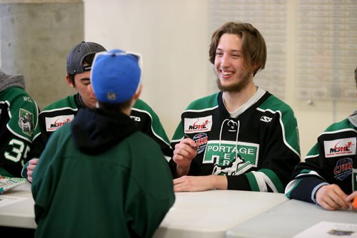 TREVOR HAGAN / WINNIPEG FREE PRESS
Portage Terriers goaltender Kurtis Chapman, talking to a young fan at a rally at Stride Place in Portage la Prairie, Wednesday, April 26, 2017.