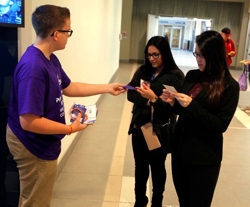 BORIS MINKEVICH / WINNIPEG FREE PRESS
Kindness Challenge:  A pay-it-forward crowd of West Kildonan Collegiate Grade 11 students help hand out 2,000 kindness idea cards and 2,000 bracelets, challenging pedestrians to perform acts of kindness, and then ask the recipients to pay it forward to others. Called The Kindness Challenge, the big-hearted project started at 8 a.m. at Cityplace, Graham Avenue entrance, main level. From left, student Scott Knight hands out the message to Roshanie Balkaran and Uyen Nguyen . Reporter Jane Gerster story. April 28, 2017