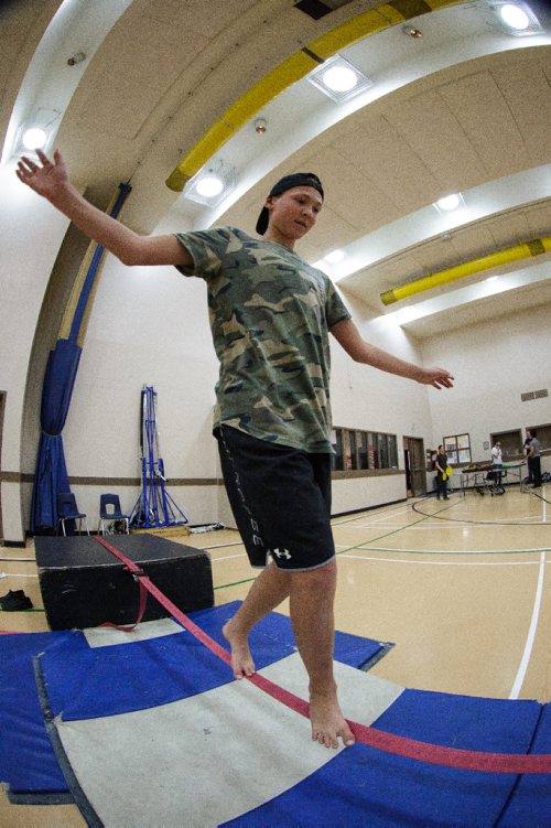 MIKE DEAL / WINNIPEG FREE PRESS
Parker Bohotchuk, 14, tries walking the tightrope during a gathering of the Winnipeg Circus Club at the Broadway Neighbourhood Centre. Anyone can join to learn how to juggle, hula hoop, ride a unicycle and walk a tightrope. 
170430 - Sunday, April 30, 2017.