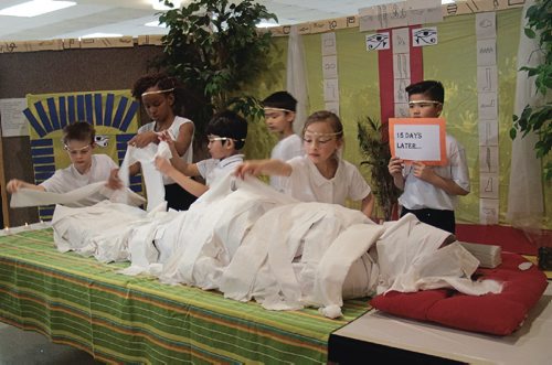 Canstar Community News April 25, 2017 - Students in Sandy Fazenda's Grade 2/3 class at Bernie Wolfe Community School (95 Bournais Dr.) prepared vice-principal Ryan Francis for "mummification" by wrapping him in linen. The group has been learning about ancient Egypt in social studies class for the past month and a half. (SHELDON BIRNIE/CANSTAR/THE HERALD)