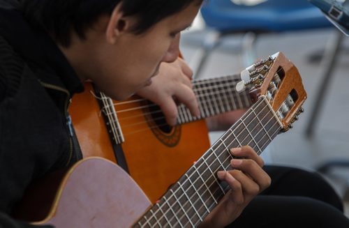 MIKE DEAL / WINNIPEG FREE PRESS
Grade 12 student Jeremy Mason, 17, from Nelson McIntyre Collegiate Guitar Ensemble performs during the Music Monday event at The Forks. Music Monday is the world's largest single event dedicated to raising awareness for music education.
170501 - Monday, May 01, 2017.