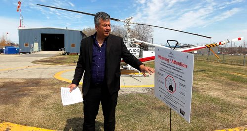 BORIS MINKEVICH / WINNIPEG FREE PRESS
Ken Nawolsky, Winnipeg's superintendent of insect control with signs people will see during insect control season. Photo taken at the insect Control Branch Heliport  620 Tyne Avenue. ALDO SANTIN STORY. May 1, 2017