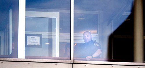PHIL HOSSACK / WINNIPEG FREE PRESS  -  Seen from Graham ave, a city police officer stands near the scene after a police shooting in the walkway at Garry street at Graham. See Mike McIntyre's story.  -  May 1, 2017