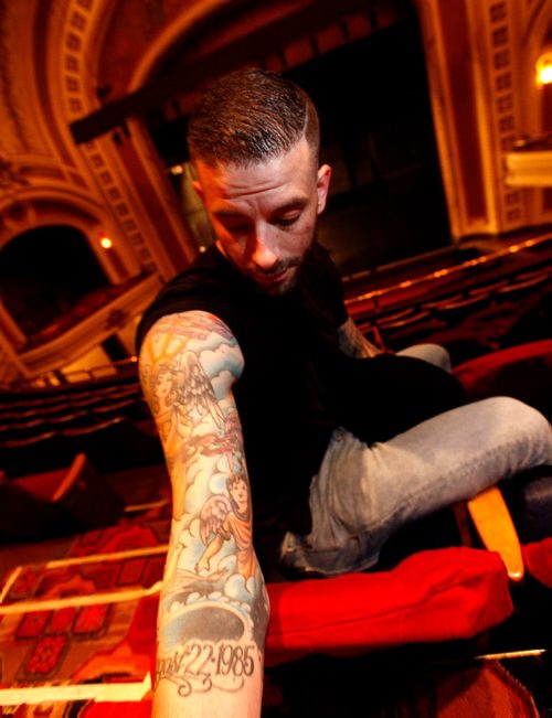 PHIL HOSSACK / WINNIPEG FREE PRESS  -  Darcy Oake poses at the Burton Cummings Theatre showing a tattoo on his arm showing an angel and two cherubs representing him and his brother Bruce who died of an over dose, dates of his birth and death are inscribed at the bottom.  -  May 3, 2017