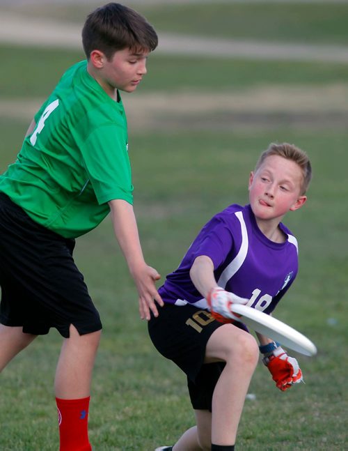 BORIS MINKEVICH / WINNIPEG FREE PRESS
Louis Riel School Division middle years Ultimate league play at Hastings School fields. From left, Shamrock School player #4 Cole Treffner defends against École Marie-Anne-Gaboury's #19 Nathan Lazarenko. STANDUP PHOTO. May 3, 2017