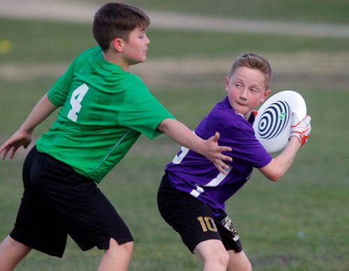 BORIS MINKEVICH / WINNIPEG FREE PRESS
Louis Riel School Division middle years Ultimate league play at Hastings School fields. From left, Shamrock School player #4 Cole Treffner defends against École Marie-Anne-Gaboury's #19 Nathan Lazarenko. STANDUP PHOTO. May 3, 2017