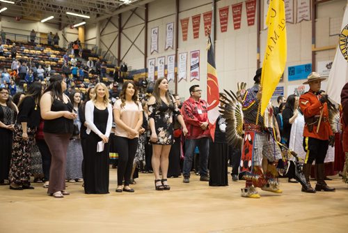 JEN DOERKSEN/WINNIPEG FREE PRESS
Grads stand alongside eagle staff carriers and flag barers who led the first Grand Entry a the University of Manitobas gradtuation traditional pow wow. Saturday, May 6, 2017.