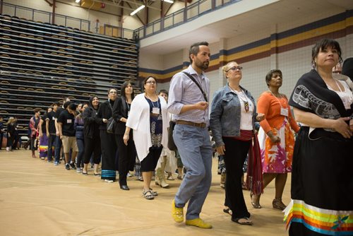 JEN DOERKSEN/WINNIPEG FREE PRESS
Grads and staff members holding tobacco and following the eagle staff bearers during the first grand entry at University of Manitobas Annual Traditional Graduation Pow Wow. Saturday, May 6, 2017.