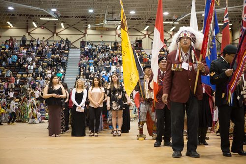 JEN DOERKSEN/WINNIPEG FREE PRESS
Grads stand alongside eagle staff carriers and flag barers who led the first Grand Entry a the University of Manitobas gradtuation traditional pow wow. Saturday, May 6, 2017.