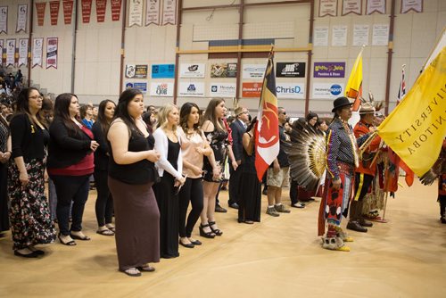 
JEN DOERKSEN/WINNIPEG FREE PRESS
Grads stand alongside eagle staff carriers and flag barers who led the first Grand Entry a the University of Manitobas gradtuation traditional pow wow. Saturday, May 6, 2017.