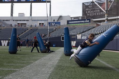JEN DOERKSEN/WINNIPEG FREE PRESS
Aidan Ross, 9, practices his tackle at the Investors Group Field for the Bombers Fan Fest day. Young athletes and families were welcomed onto the field 
to hone their football skills. Saturday, May 6, 2017.