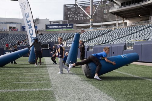
JEN DOERKSEN/WINNIPEG FREE PRESS
Brothers Raylund Ross, 10, and Aidan Ross, 9, practice tackles at the Investors Group Field for the Bombers Fan Fest day. The boys attend Bombers game every year with their grandmother, Pat Williams, who has had season tickets since 1985. Saturday, May 6, 2017.