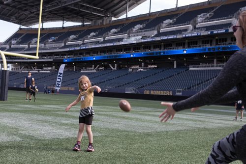 JEN DOERKSEN/WINNIPEG FREE PRESS
Calliope Dickens, 4, practices her throw a small football at Investors Group Field during the Bombers Fan Fest this weekend. Young athletes were welcomed to come practice their football skills on the pro field. Saturday, May 6, 2017.