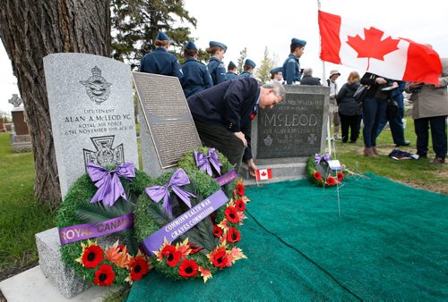 WAYNE GLOWACKI / WINNIPEG FREE PRESS

Alan Arnett Adams places a Canadian flag after the Victoria Cross headstone commemoration ceremony held Tuesday for his uncle First World War soldier Lieutenant  Alan McLeod VC at the Old Kildonan Presbyterian Cemetery.  Lt. McLeod is buried along with his parents in the Old Kildonan Presbyterian Cemetery.  A private family headstone commemorated Lt.McLeod and his parents. Since this headstone is not marked with the Victoria Cross, the Commonwealth War Graves Commission (CWGC) engraved a new headstone and plaque at left that was unveiled Tuesday.
Ashley Prest story  May 9 2017